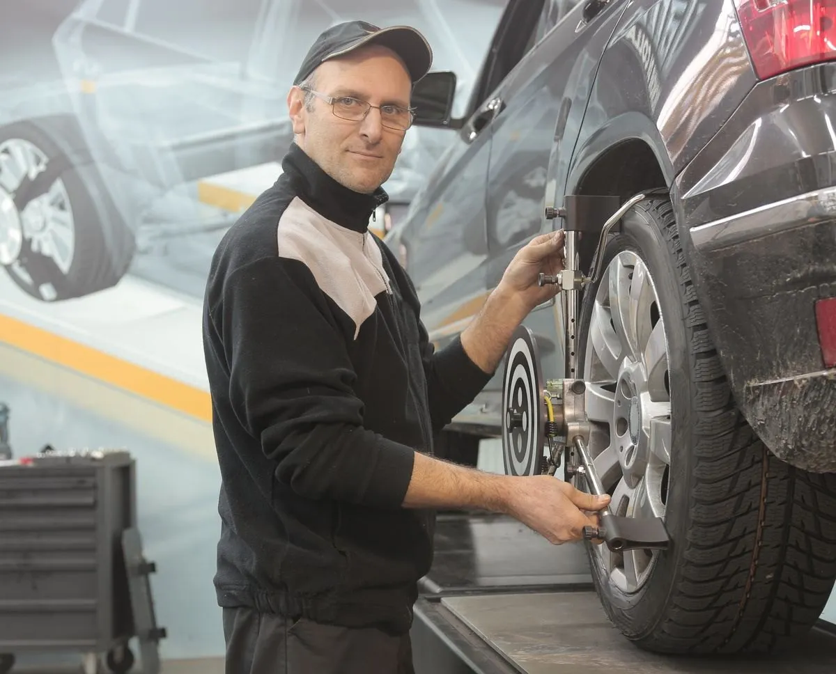 Technician checking a car wheel