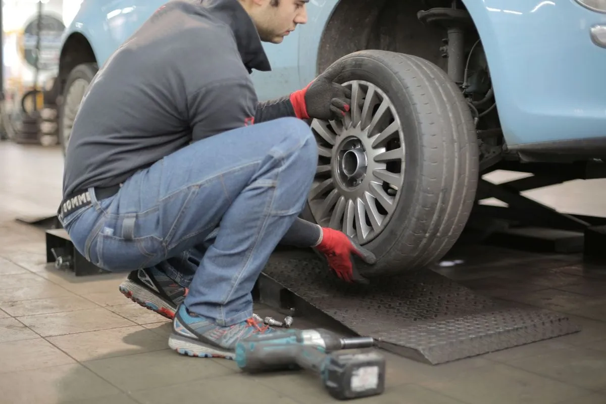Technician fitting a wheel