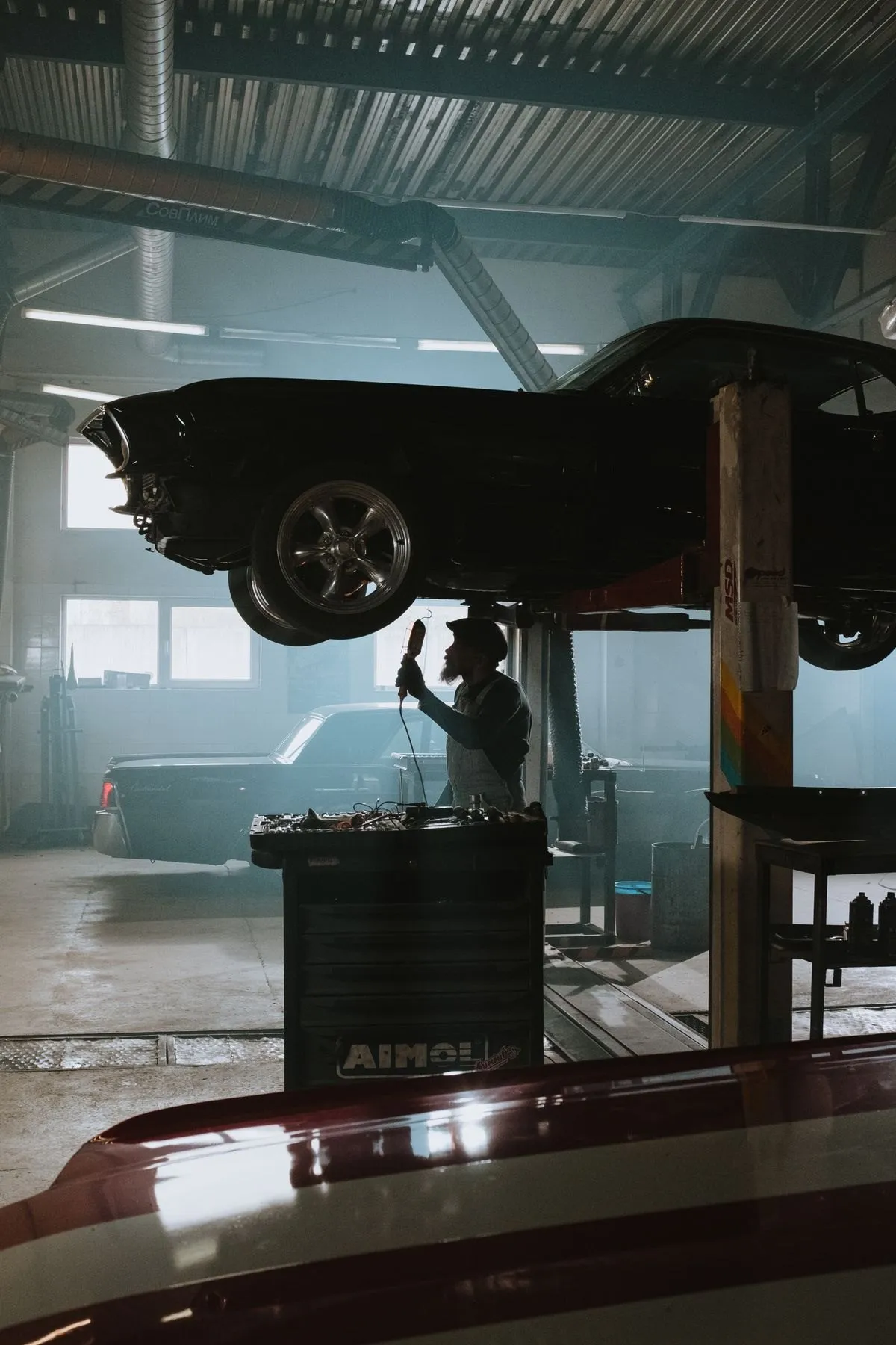 Car on a lift in a tyre service bay